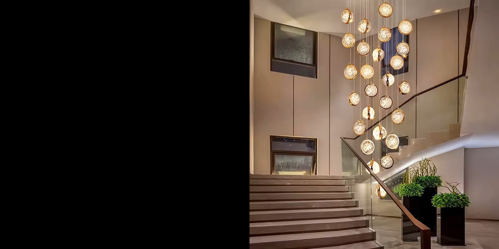 Staircase with modern chandelier and decorative plants in a home setting