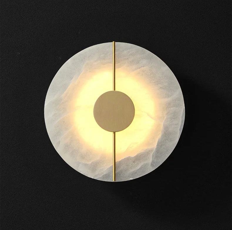 Modern wall light fixture with a gold accent on a black background